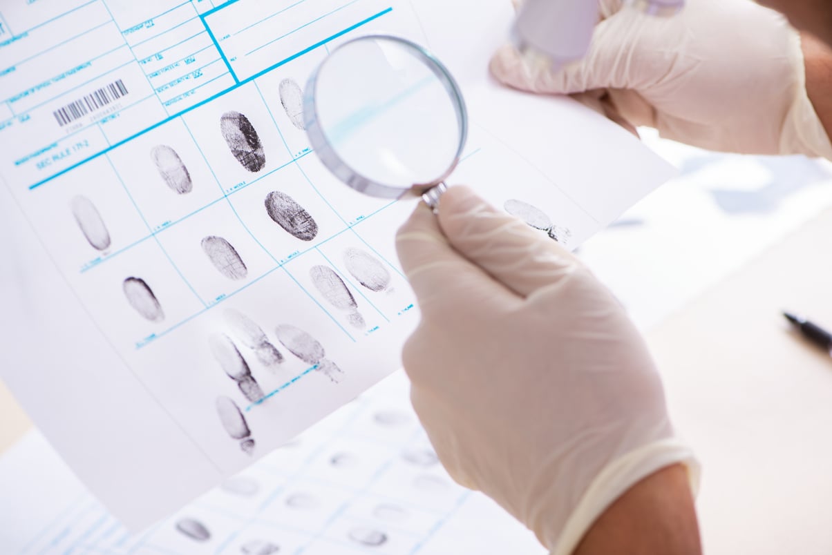 Forensic Expert Studying Fingerprints in the Lab